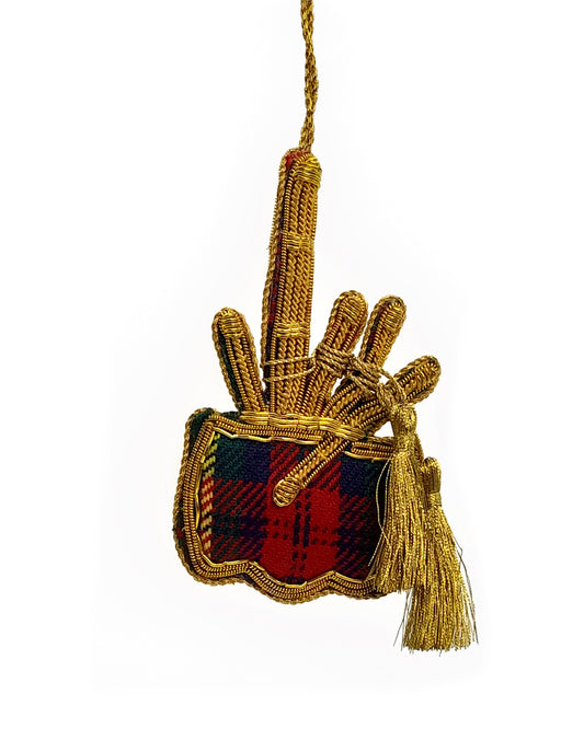 A Christmas decoration in the shape of a miniature tartan bagpipe with a red and blue plaid pattern and a golden tassel.