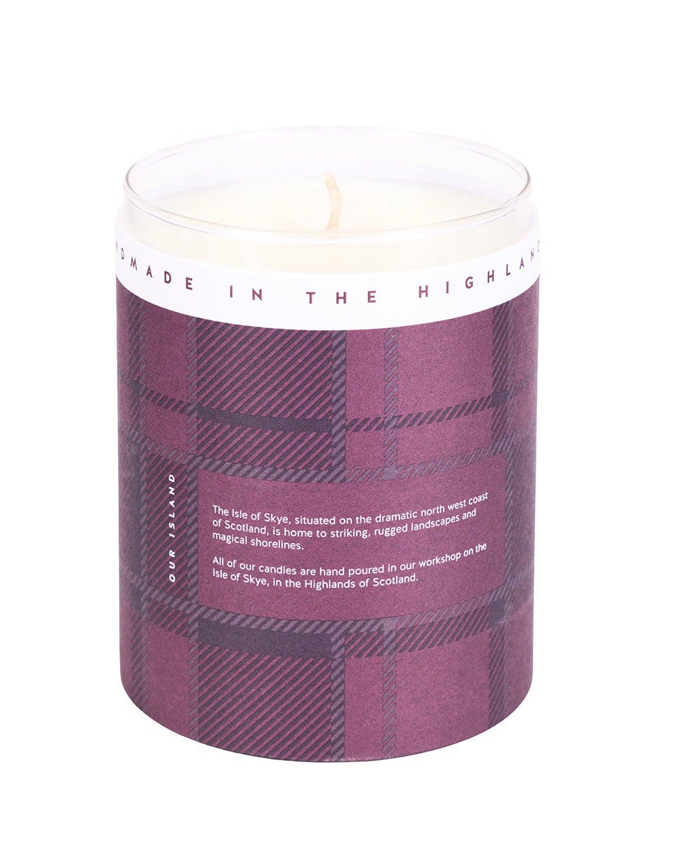 Candle with plaid design and text on a white background