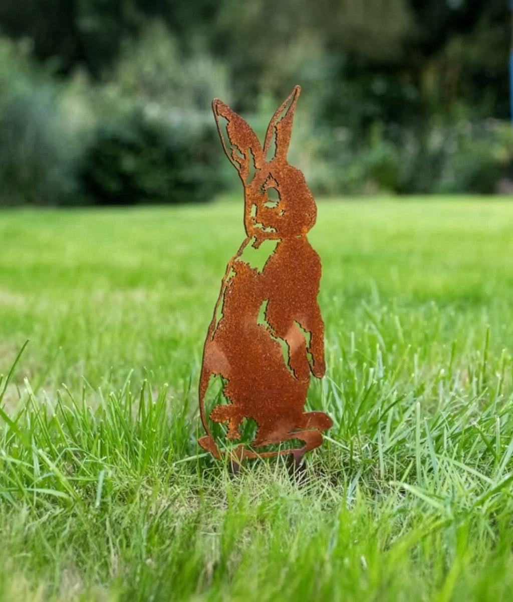 Rusted Rabbit Ground Spike set in a grass lawn