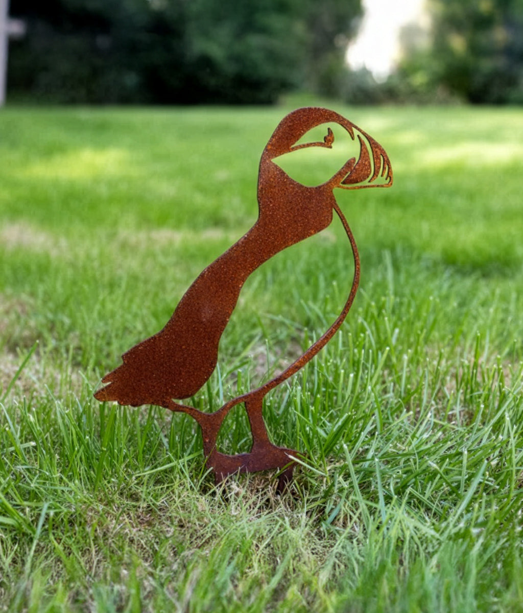 Rusted Puffin Ground Spike sitting in a grass lawn