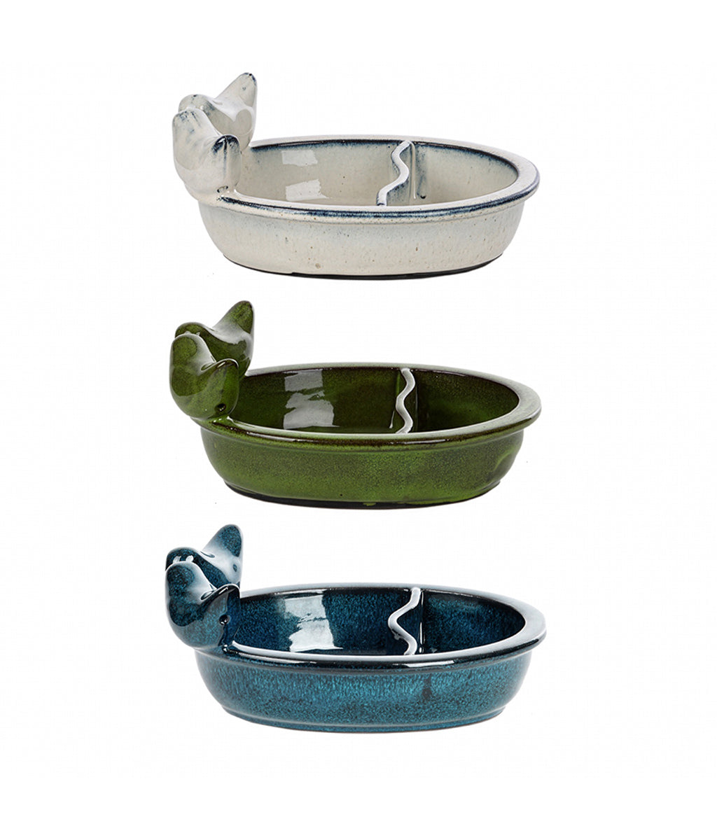Three ceramic bird baths in different colours with bird designs on a white background