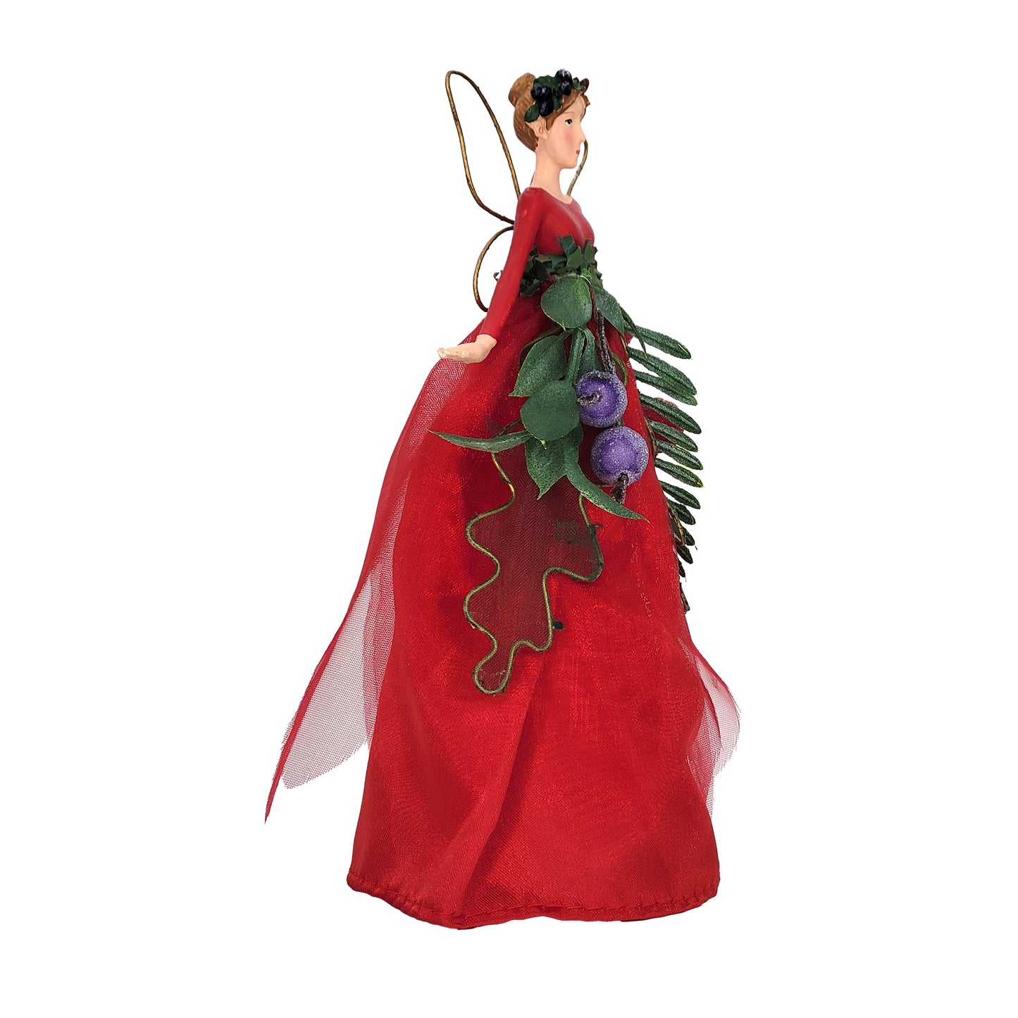 A Christmas fairy ornament with a long red gown, green leafy garland, red and purple frosted berries, and gold wings, shown on a plain white background.