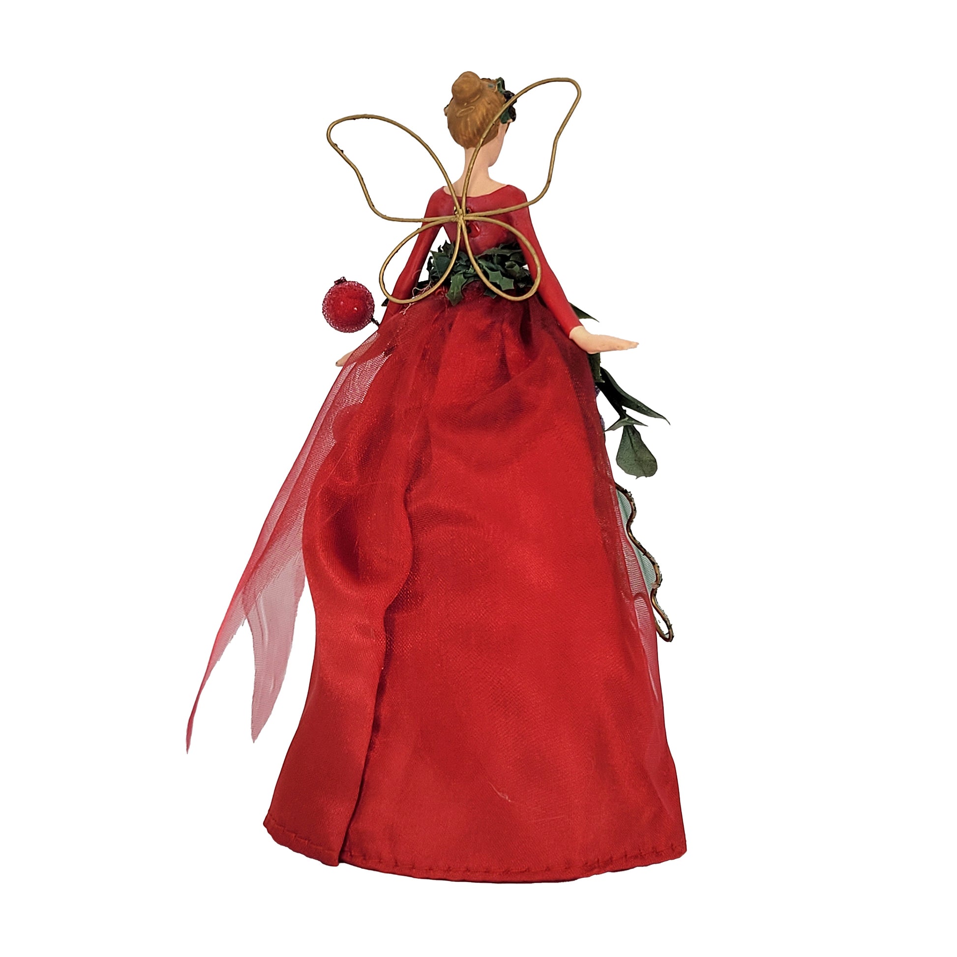 A Christmas fairy ornament with a long red gown, green leafy garland, red and purple frosted berries, and gold wings, shown on a plain white background.