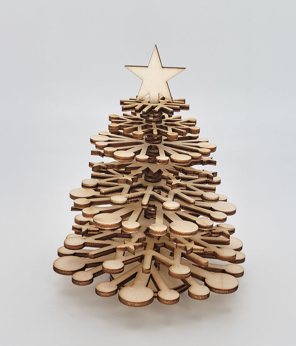 Wooden Christmas tree with a star on top against a light gray background