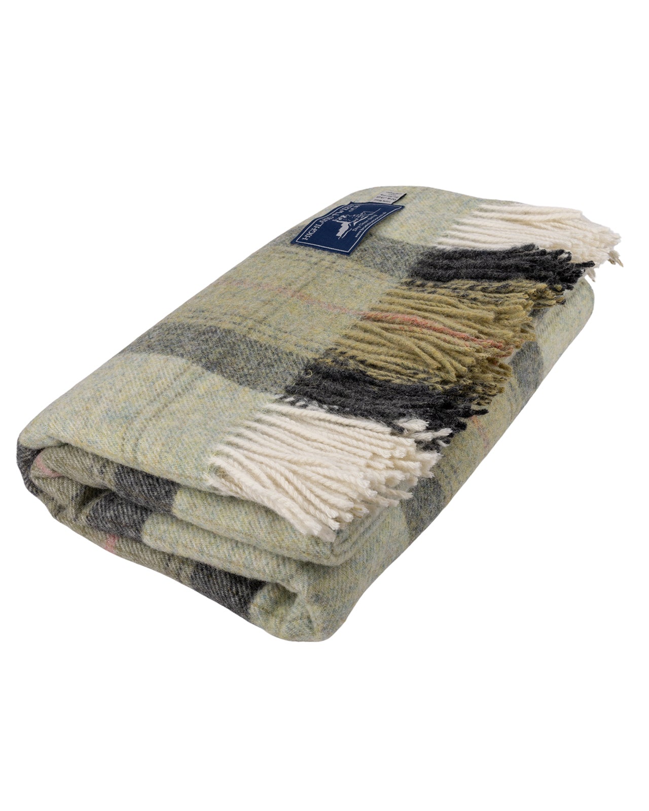 A folded Skye Green Pure New Wool Throw Blanket with cream fringe, featuring a mix of sage green, gray, black, and beige tones, with a small blue brand label.