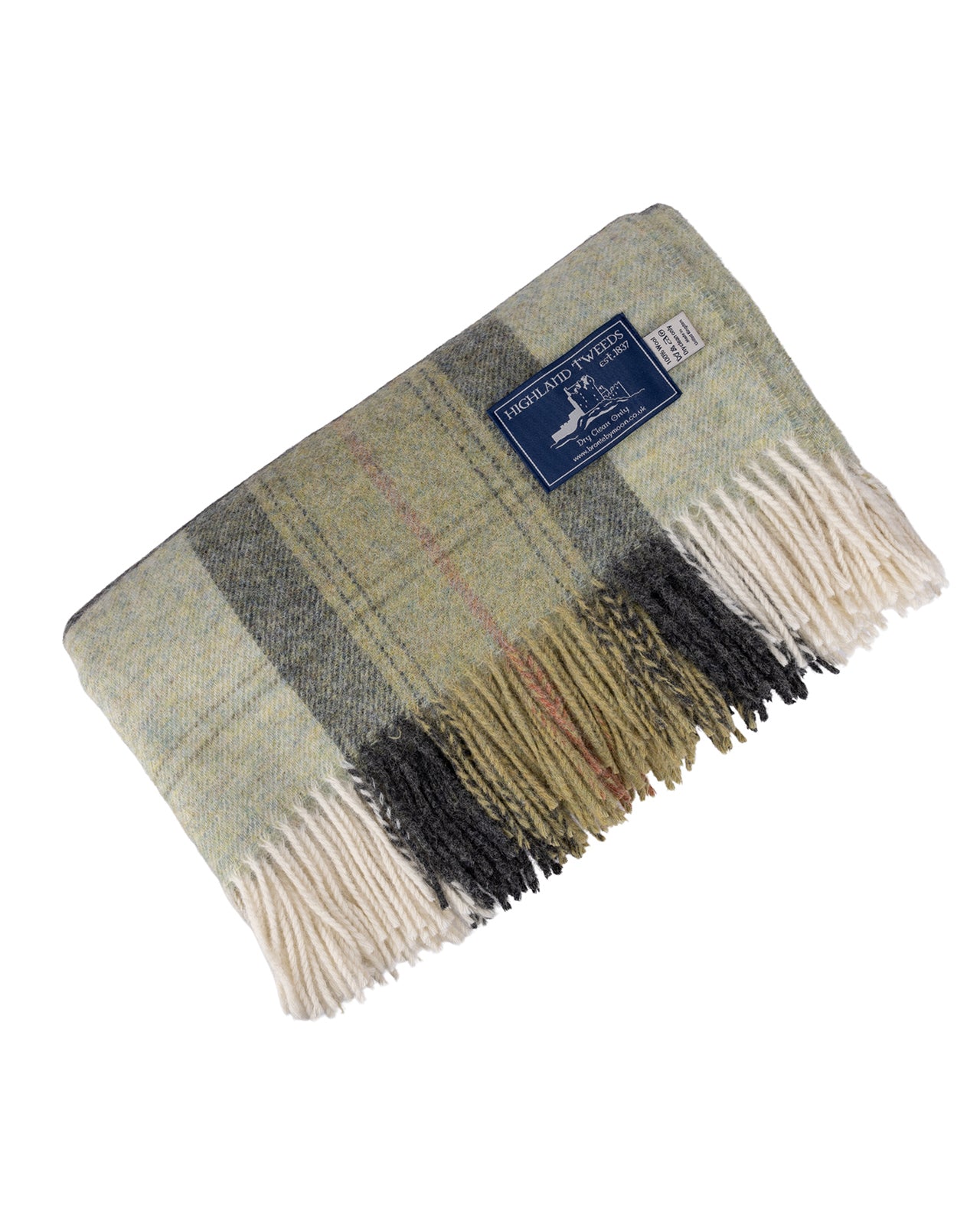 A folded Skye Green Pure New Wool Throw Blanket with cream fringe, featuring a mix of sage green, gray, black, and beige tones, with a small blue brand label.