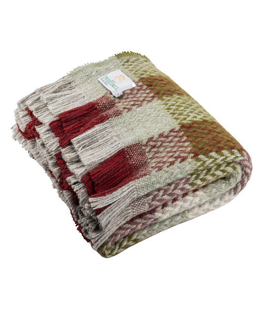 Woven blanket with red and green pattern on a white background