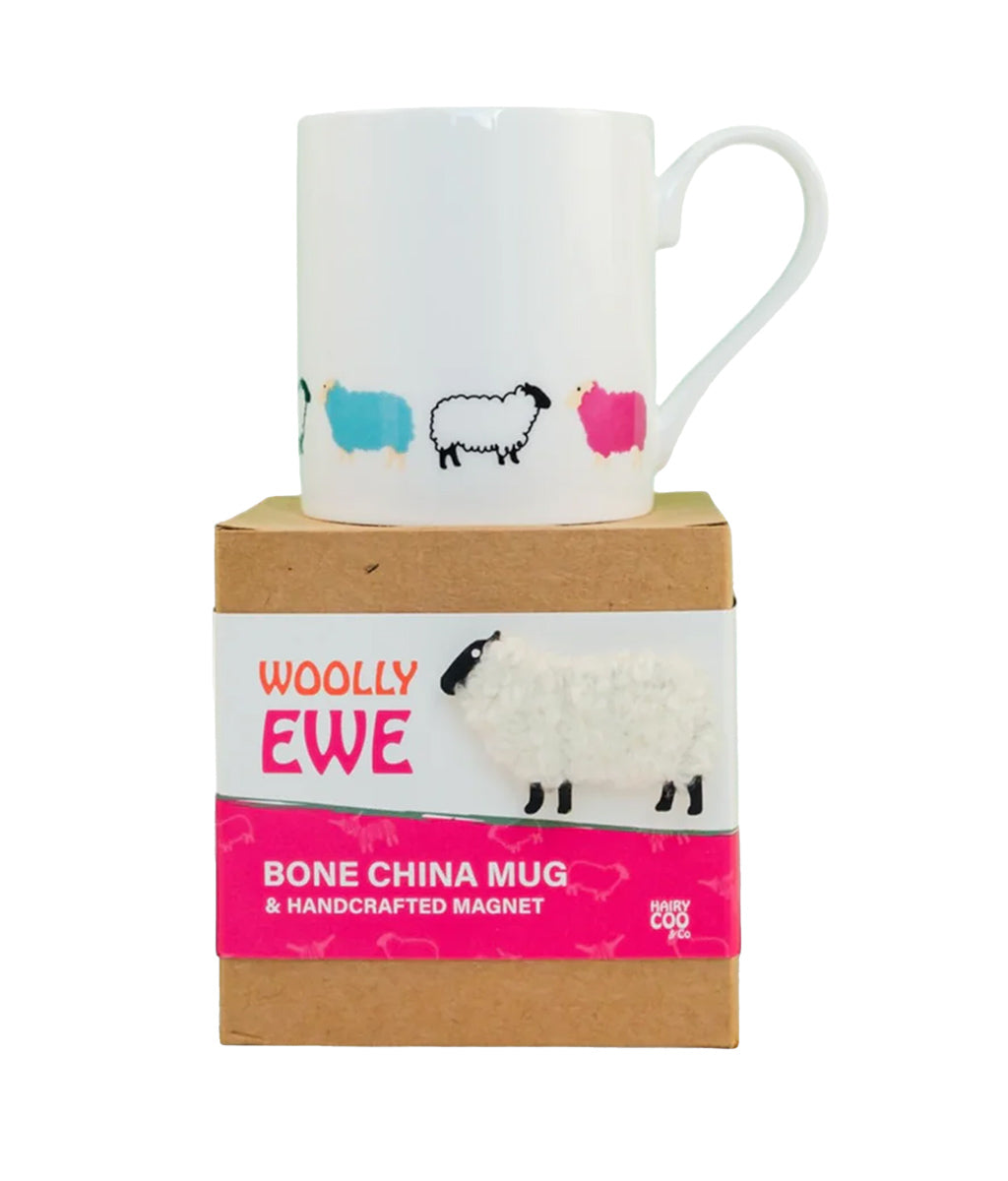 White mug with sheep design on a wooden box labeled 'Woolly Ewe' on a white background