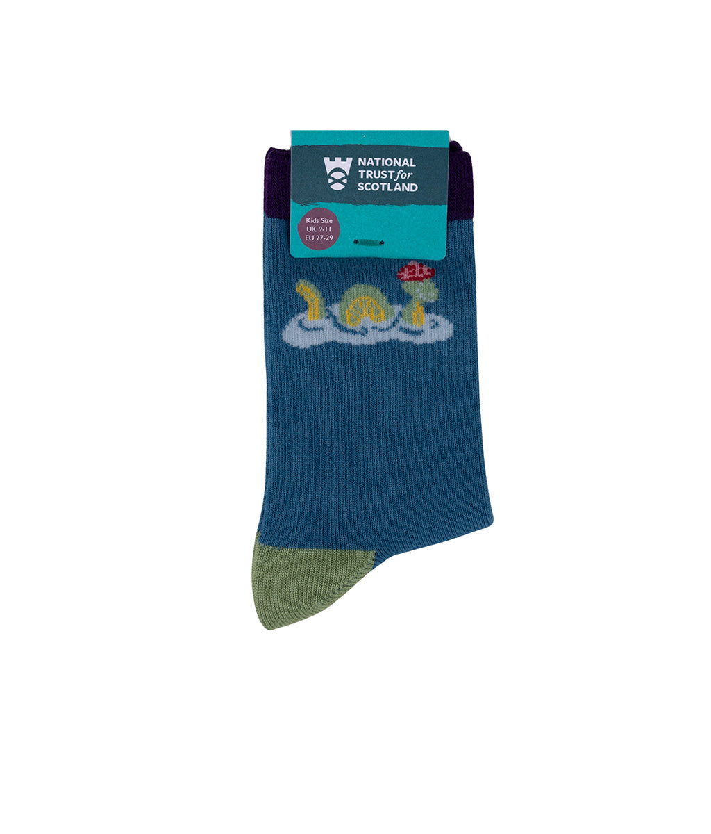 Kids blue socks with a Nessie - Loch Ness Monster design and National Trust for Scotland packaging on a white background
