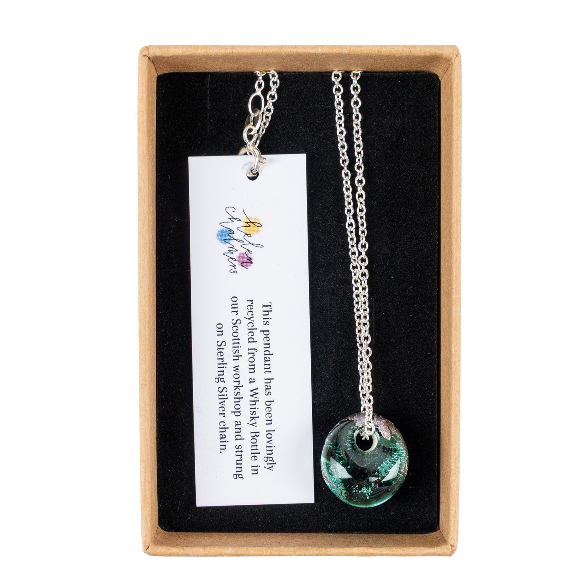 Recycled Whisky Bottle Opal Glass and Palladium Pendant on Sterling Silver Chain is presented inside a light brown gift box with a black lining and a white product tag.