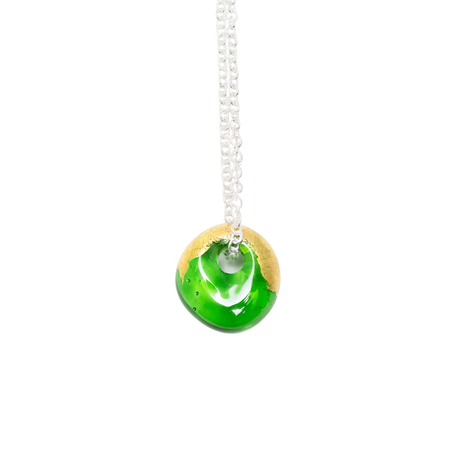 A round glass pendant necklace with a vibrant green and gold design, suspended from a silver chain against a plain white background.