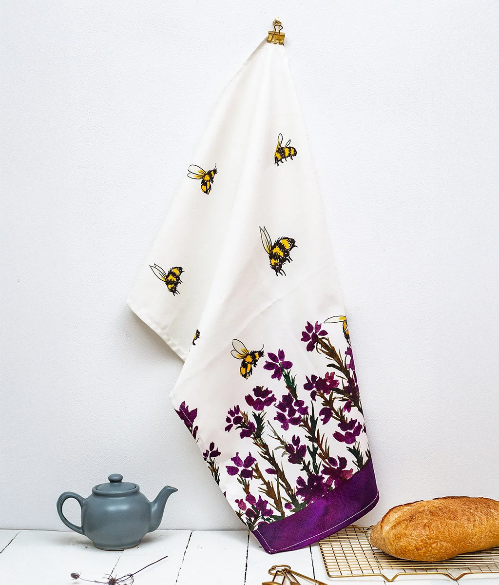 Heather & Honey Pattern Tea Towel by Sarah Leask hanging on a wall