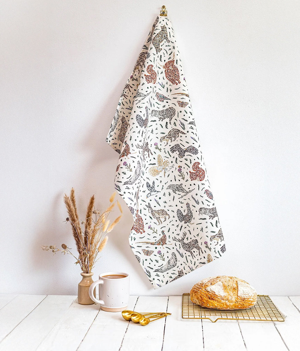 Wildlife Tea Towel by Sarah Leask hanging on a wall