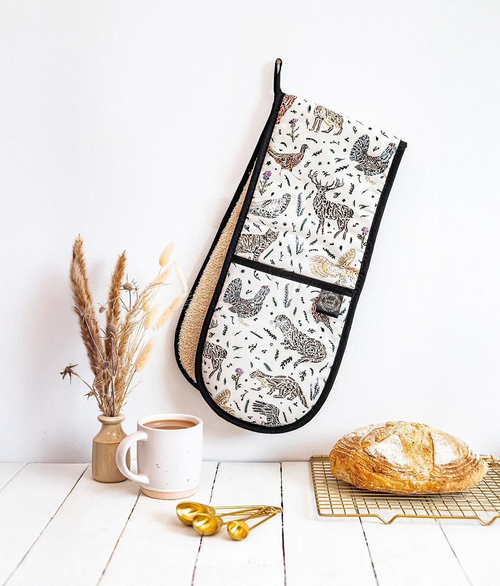 Scottish Wildlife Oven Gloves by Sarak Leask hanging on a wall