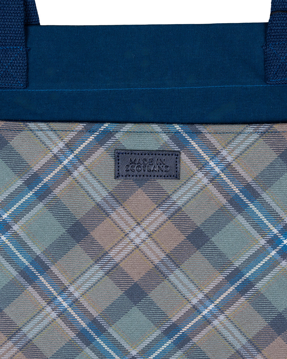 Plaid patterned bag with a visible brand logo on a white background