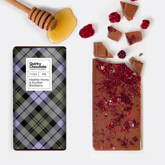 Quirky Heather Honey and Blackberries Chocolate Bar with plaid packaging and a honey dipper on a white background
