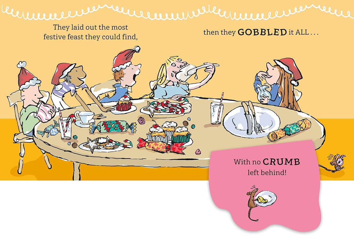 A whimsical illustrated children's book page showing a family dining table covered in holiday treats and crackers, with a pink speech bubble at the bottom reading 'With no CRUMB left behind!' and a small mouse at the lower right.