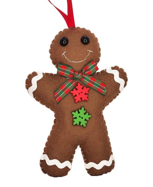 A brown felt gingerbread man Christmas ornament with white icing details, a red and green plaid bow, a red snowflake, and a green snowflake on the front, complete with a red hanging ribbon.