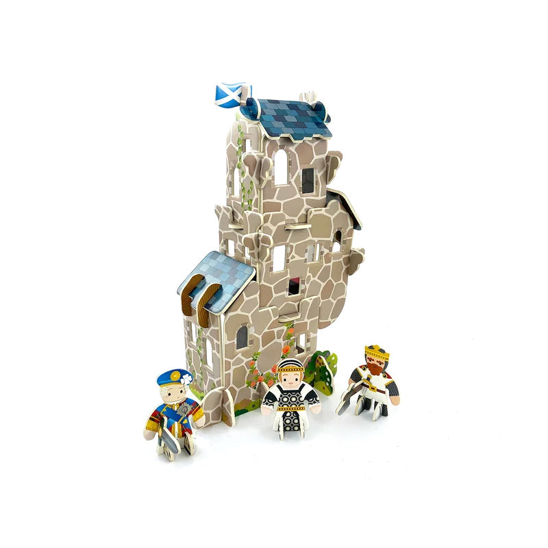 A 3D cardboard toy set featuring a medieval Scottish stone tower with a blue flag, accompanied by three small minifigures in historical and royal attire on a plain white background.