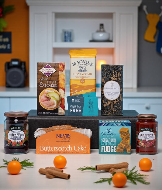 Assorted food products including jars, boxes, and a cake on a kitchen counter.