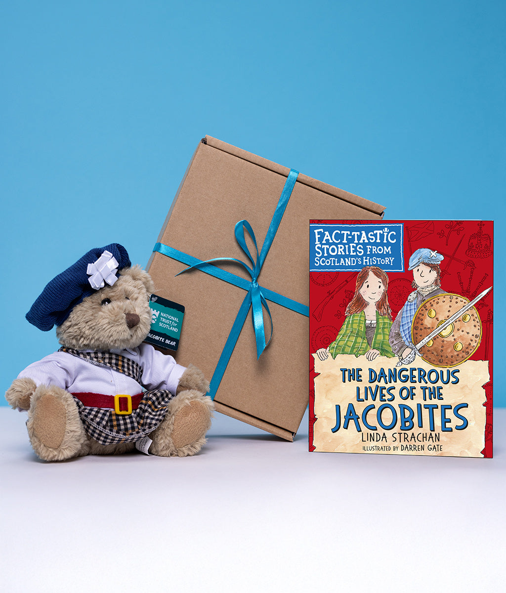 Teddy bear in Jacobite costume with a gift box and children's book titled 'The Dangeroud Lives of the Jacobites' on a blue background
