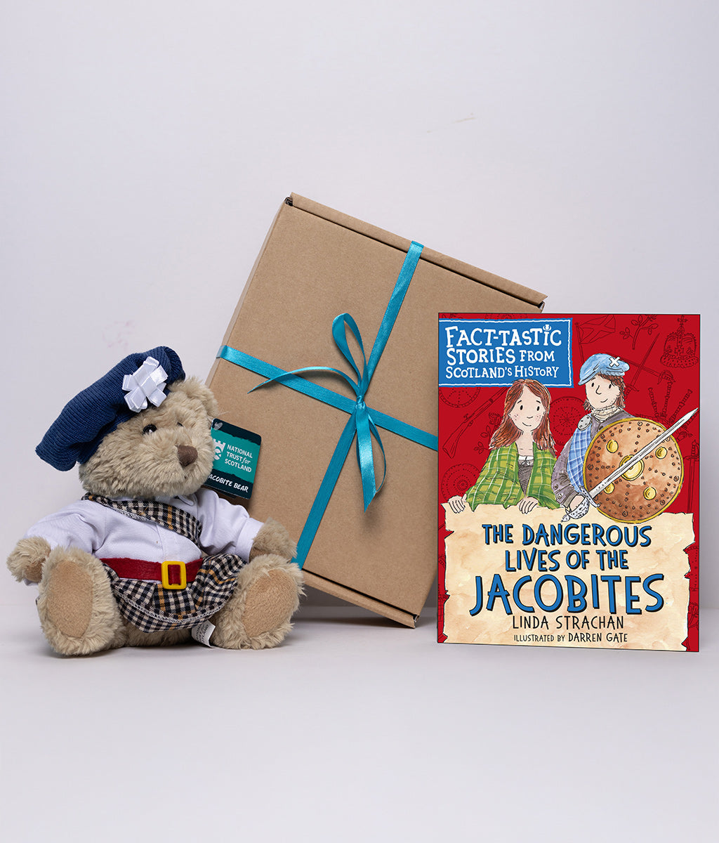 Teddy bear in Jacobite attire with a gift box and children's book titled 'The Dangerous Lives of the Jacobites' on a white background