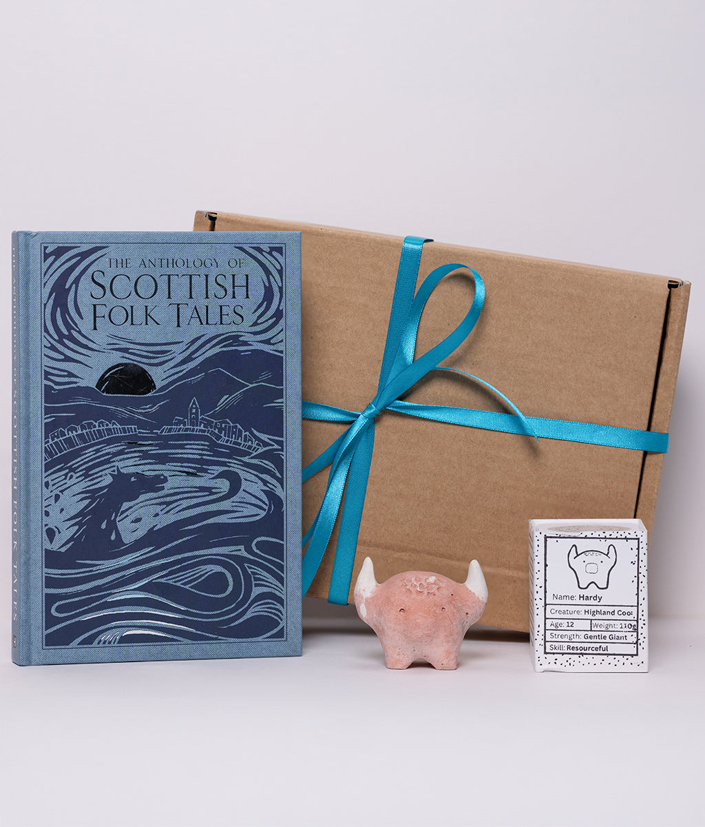 Book titled 'The Anthology of Scottish Folk Tales' with a decorative box and small figurine on a white background