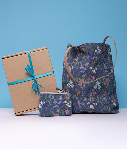 Wild Flower Purse & Bag Gift Box. Floral-patterned bag, box, and pouch on a blue background