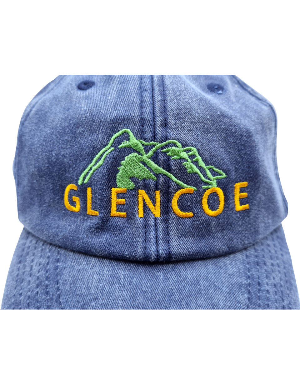 Blue denim cap with embroidered 'Glencoe' and mountain design on a white background
