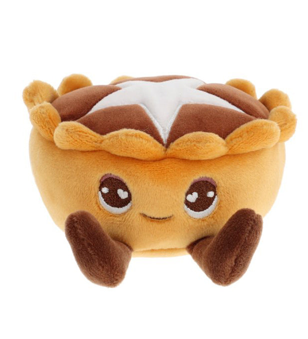 Plush toy resembling a dessert with a face on a white background