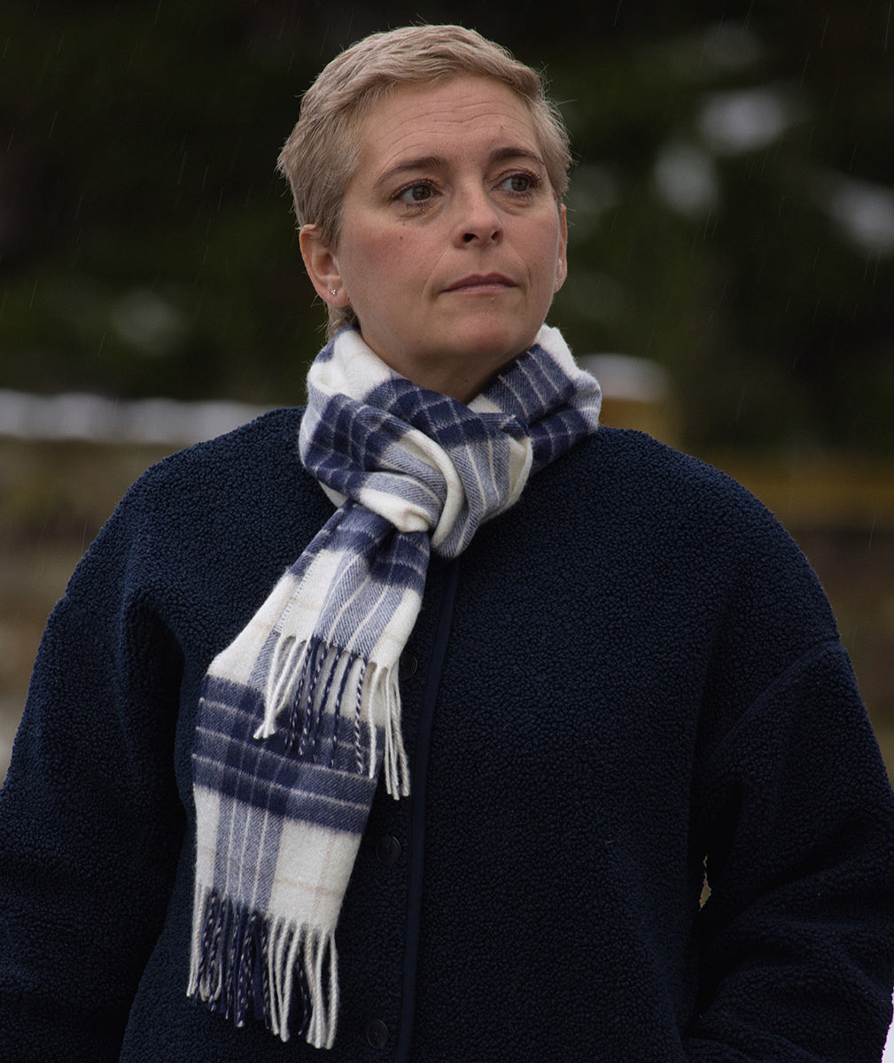Lady wearing a Knockmore Tartan Cashmere Scarf with rainy backdrop