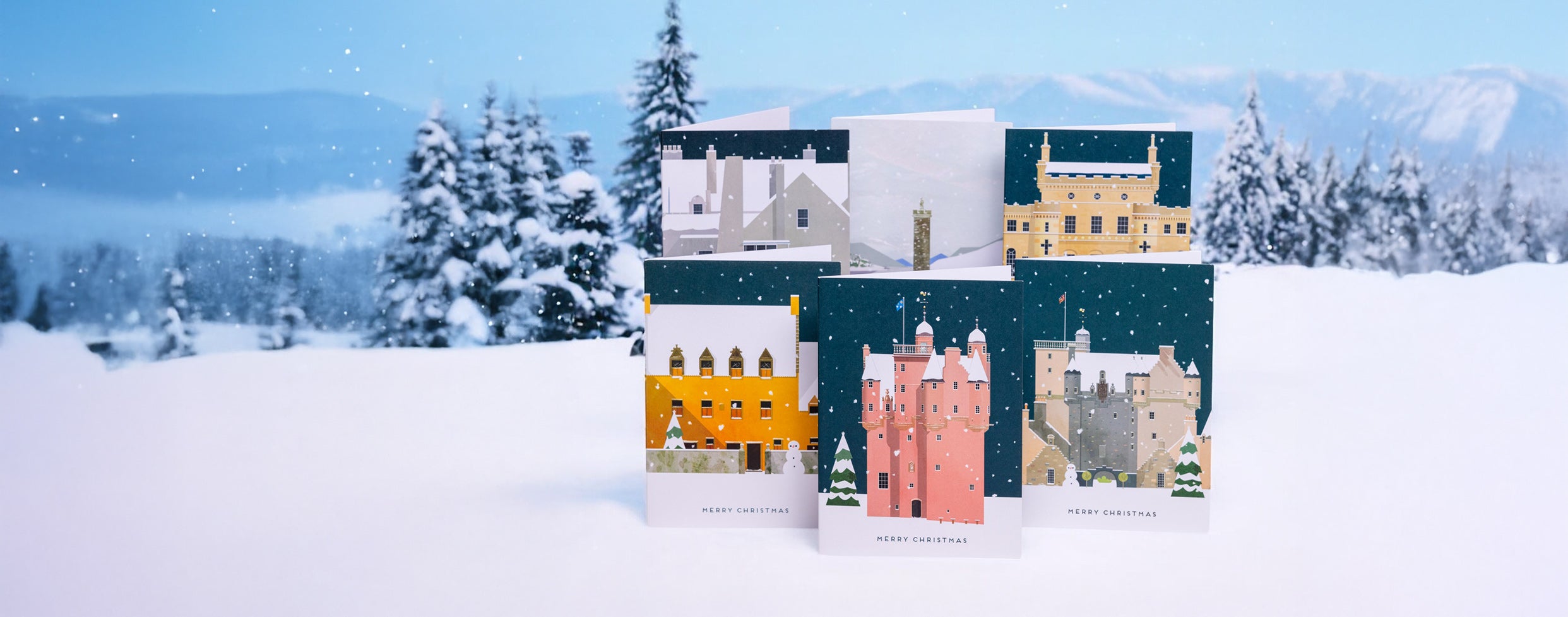 Set of Christmas cards with snowy village designs on a snowy background