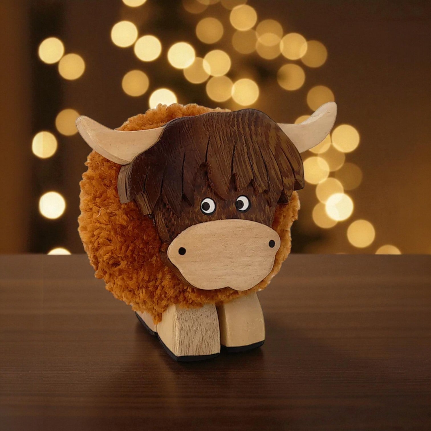 Wooden toy bull with a brown and beige color scheme against a blurred light background