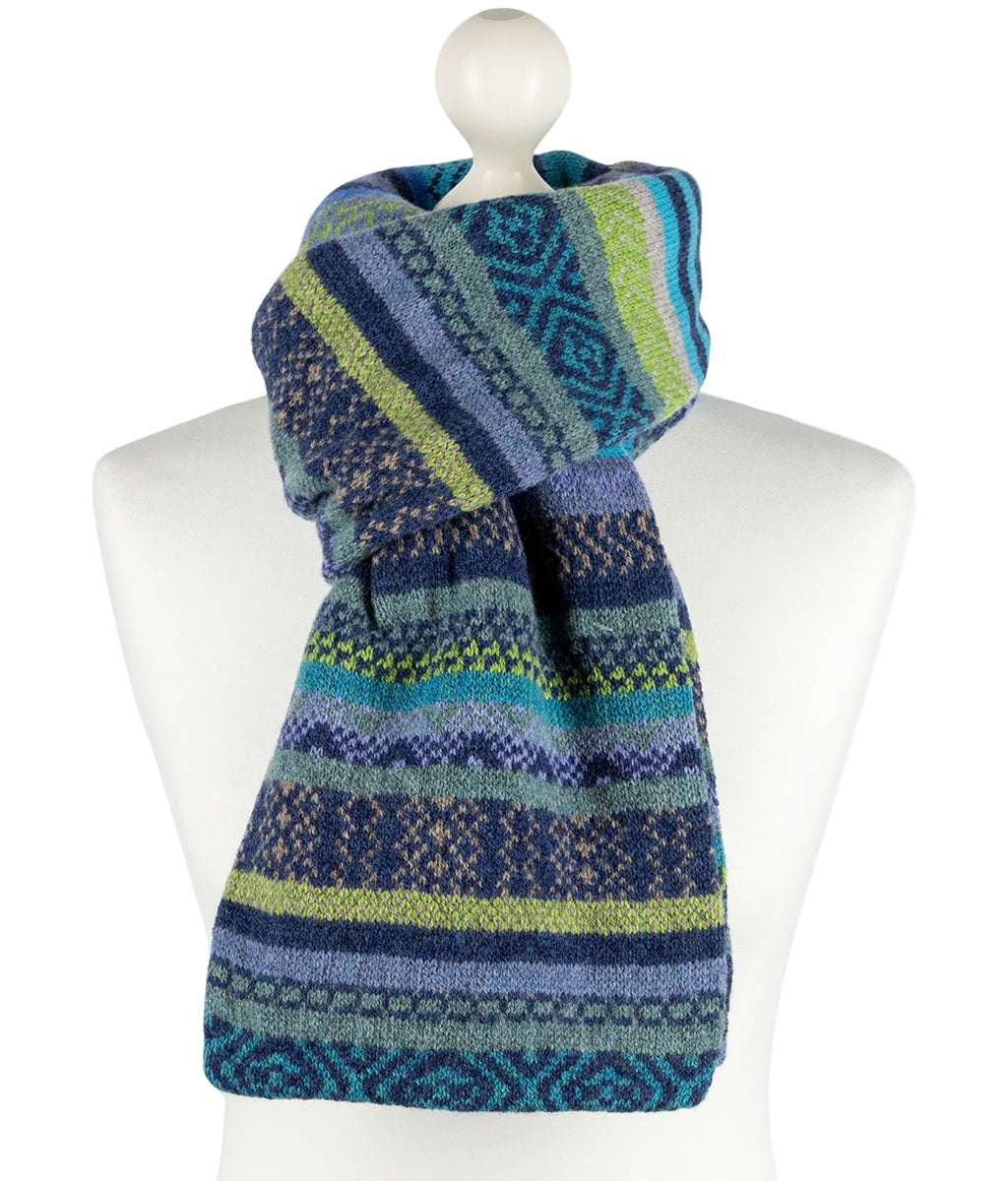 Knitted scarf with blue and green pattern on a mannequin against a white background