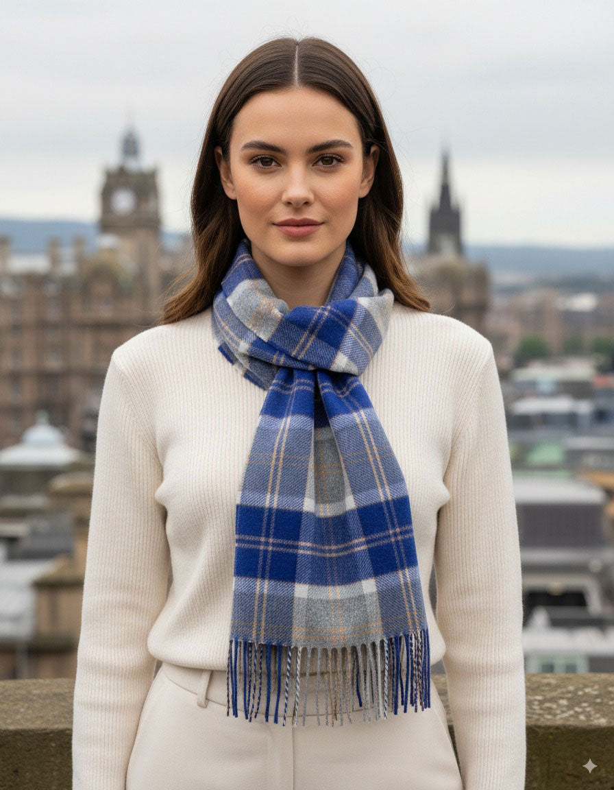 Woman wearing a blue plaid scarf with a cityscape in the background