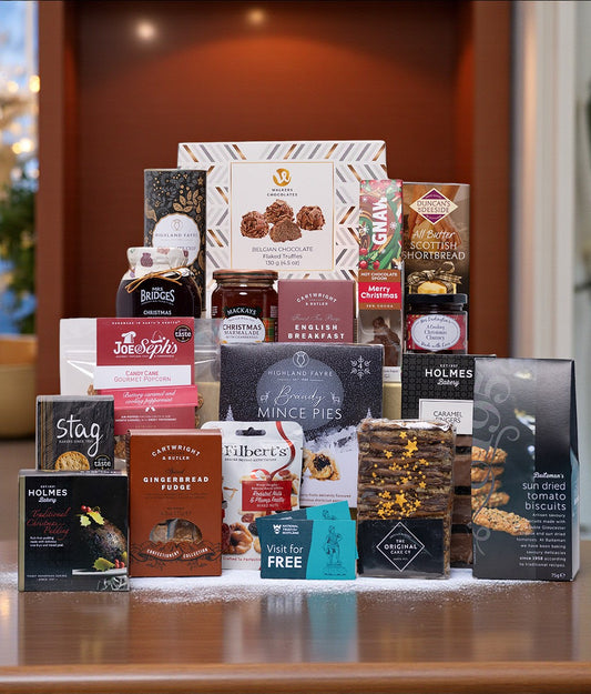 Assorted food products including jars, boxes, and tins on a wooden surface with a blurred background.