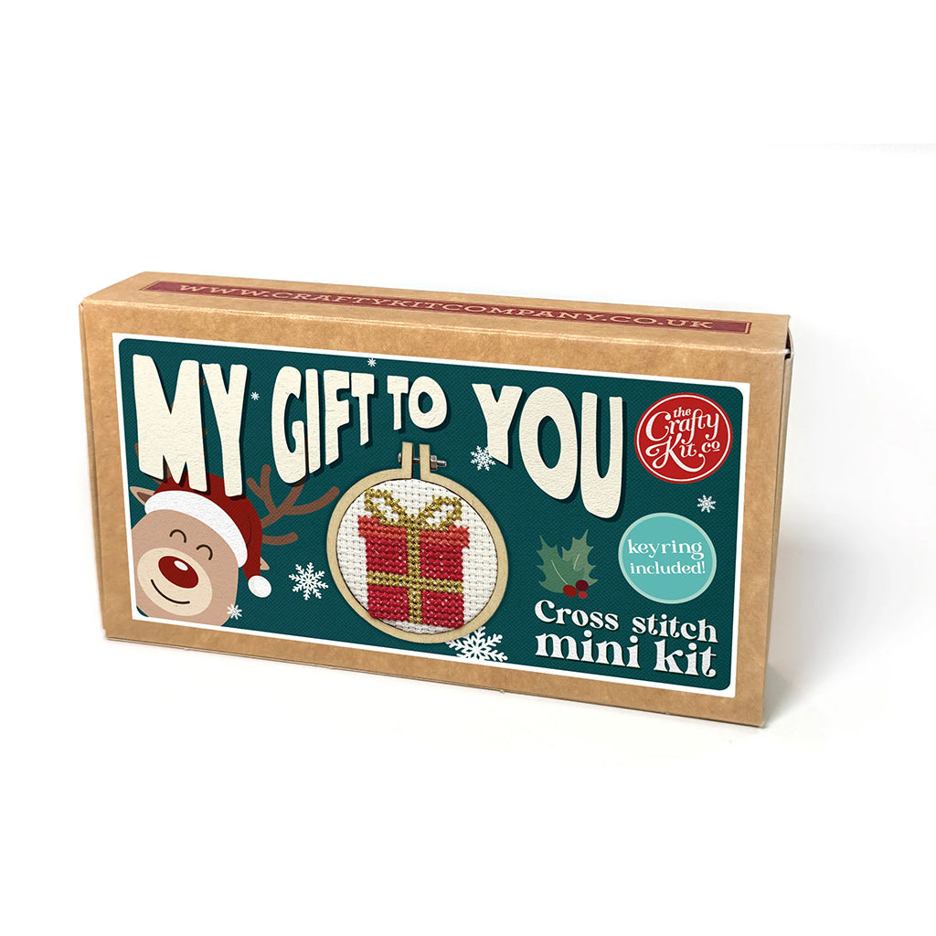 Cross stitch mini kit packaging with festive design and text on a white background