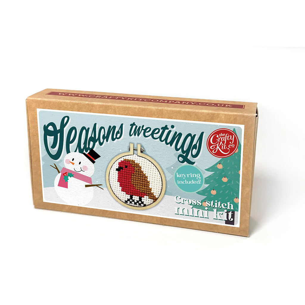 Cross stitch kit box with a snowman and robin design, featuring 'Seasons Tweetings' text.