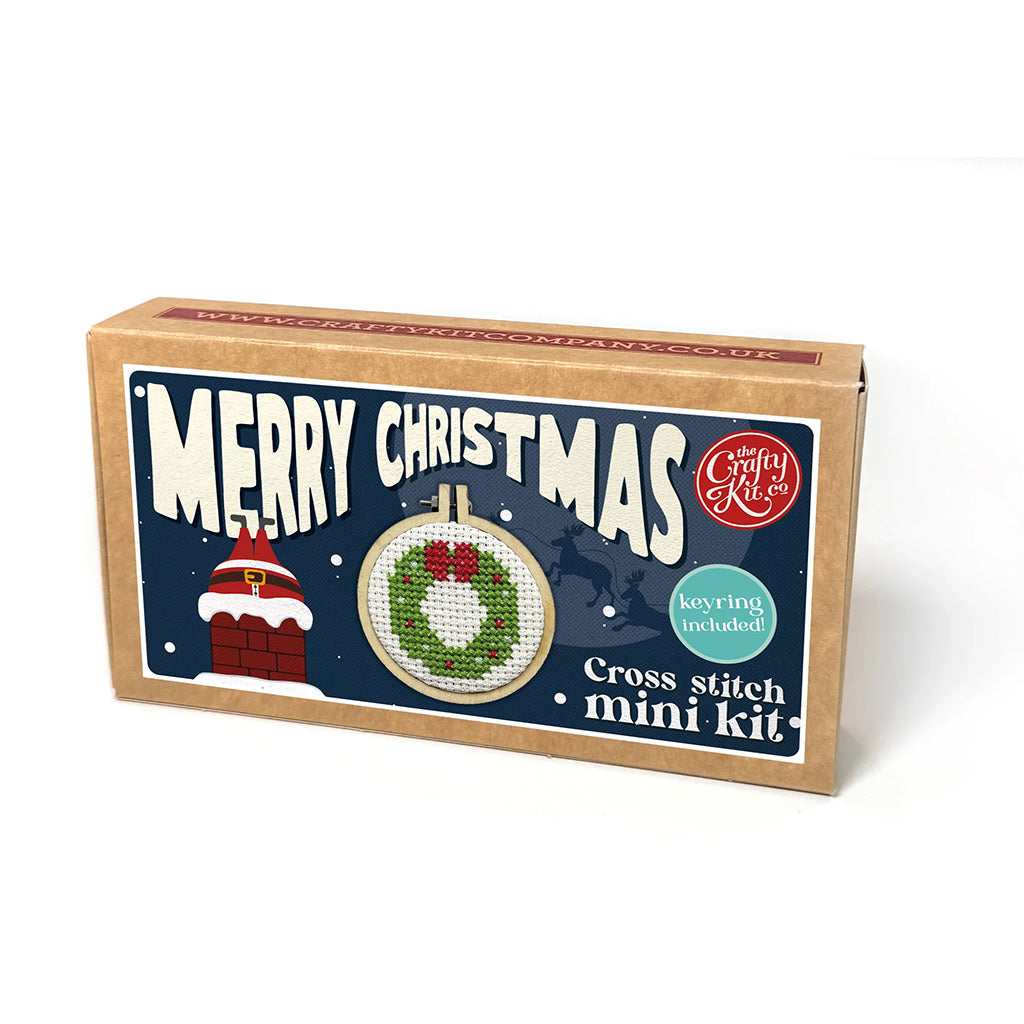 Cross stitch mini kit packaging with Christmas design on a white background