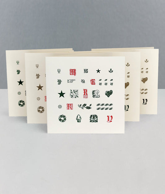 Set of Robert Smails Merry Christmas greetings cards with decorative letter stamps on a grey background