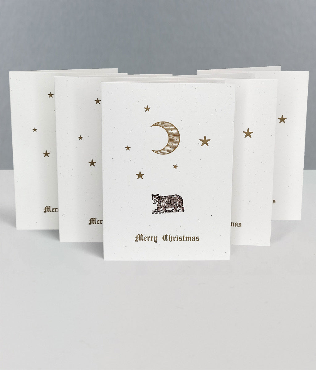 Set of Christmas cards with celestial designs and 'Merry Christmas' text on a grey background