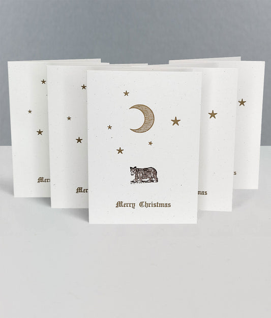 Set of Christmas cards with celestial designs and 'Merry Christmas' text on a grey background