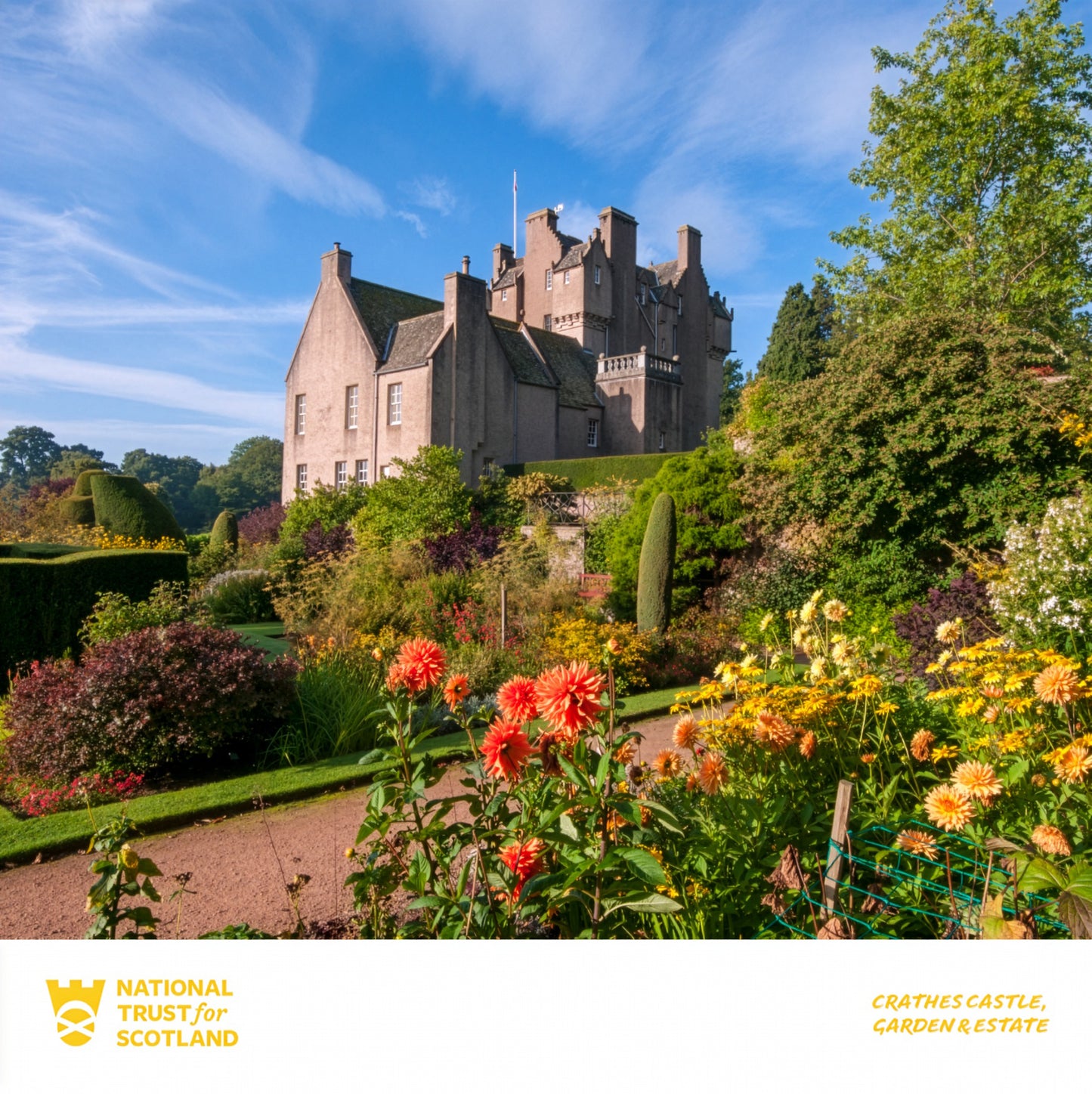 Crathes Castle with gardens and flowers on a sunny day, featuring the National Trust for Scotland logo.