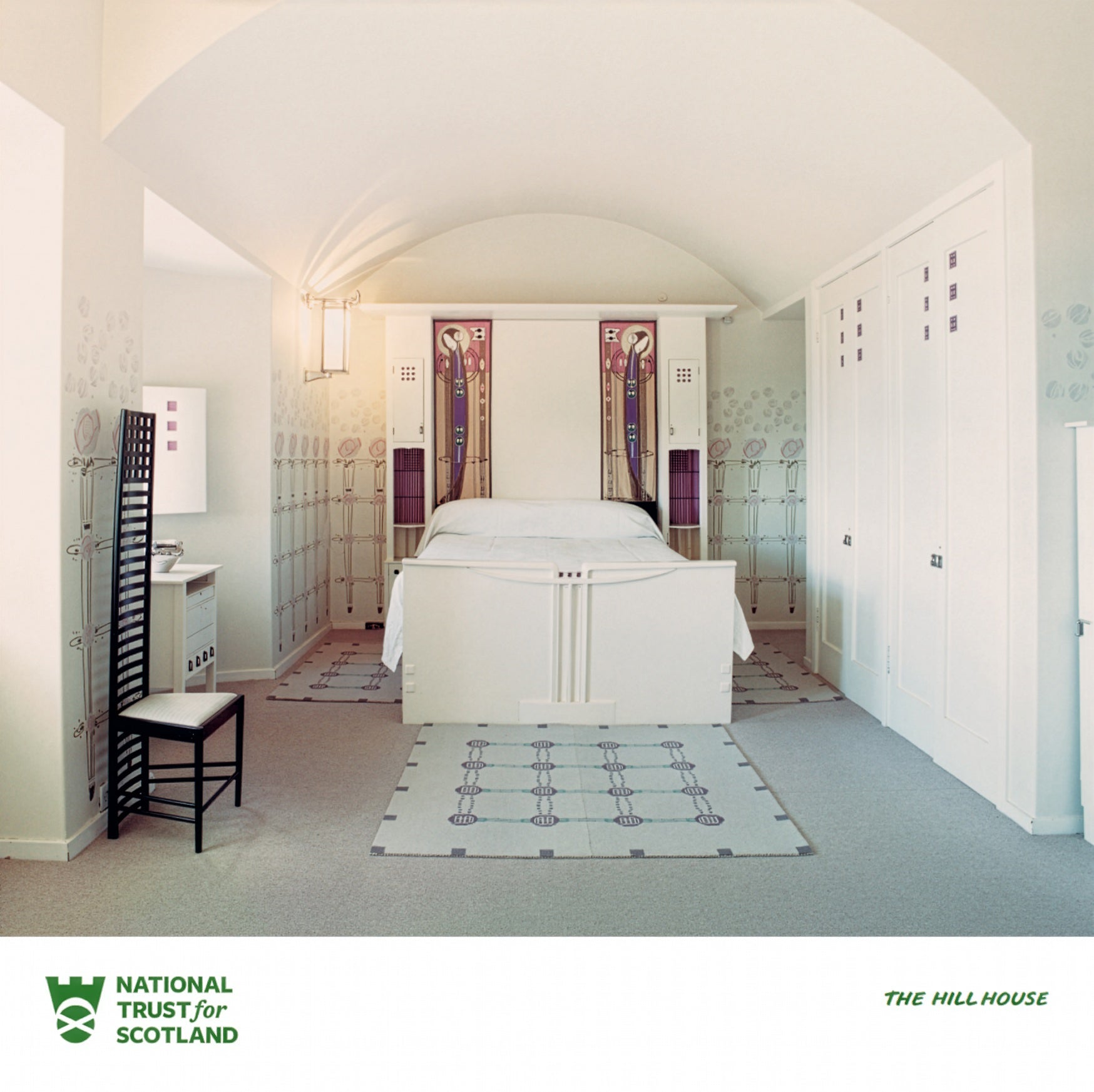 The Hill House bedroom with white bed and geometric rug, featuring National Trust for Scotland logo.