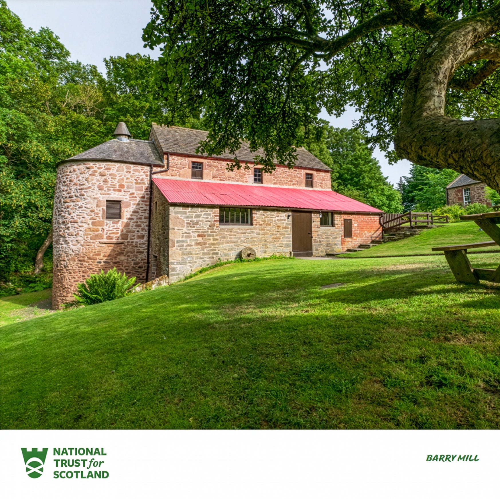 Barry Mill stone building with a red roof in a park-like setting with trees and grass, featuring the National Trust for Scotland logo.