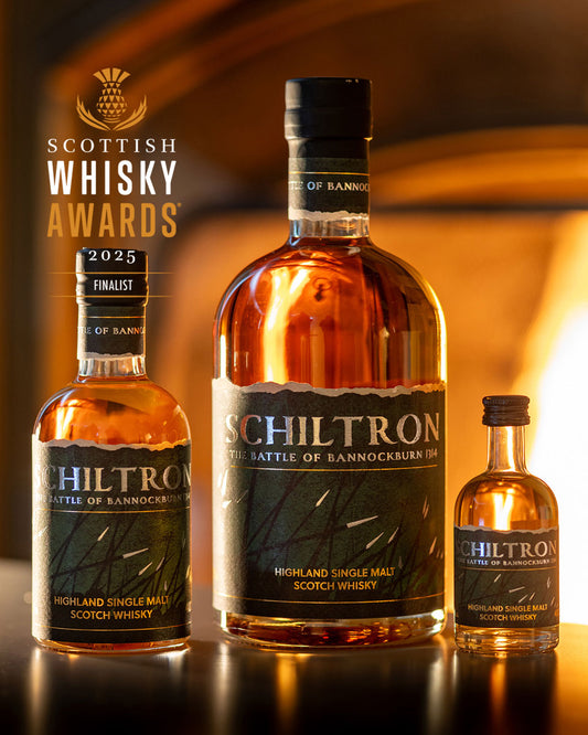 Three bottles of Schiltron Highland Single Malt Scotch Whisky on a reflective surface with a warm background.