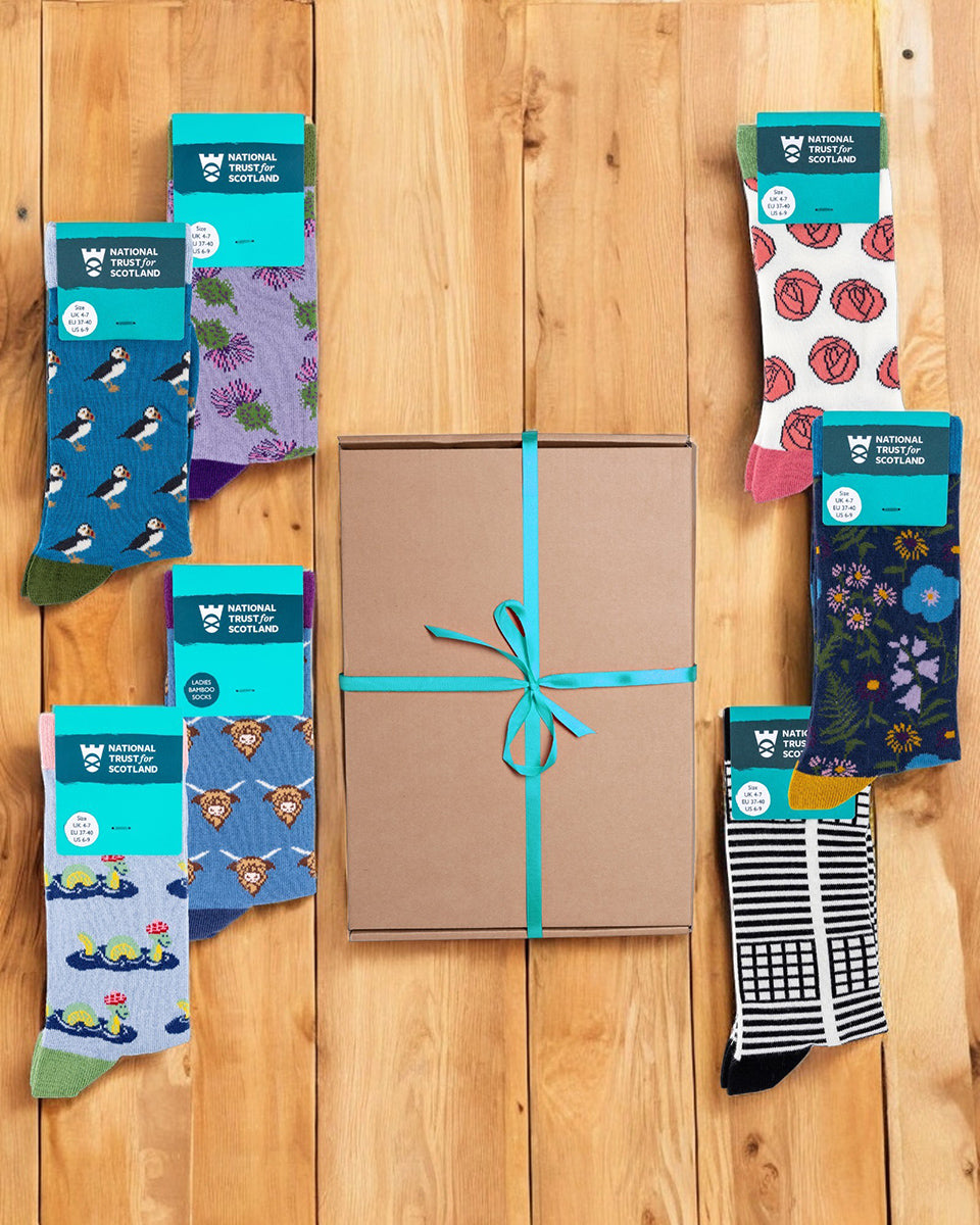 Assorted pairs of socks with different patterns on a wooden surface