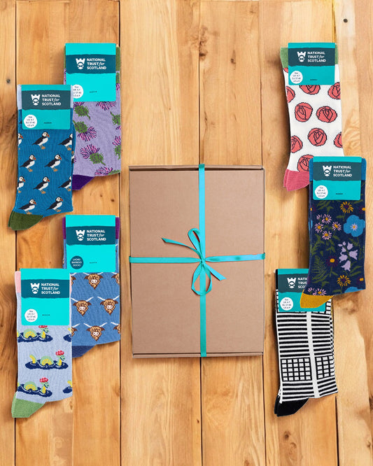 Assorted pairs of socks with different patterns on a wooden surface