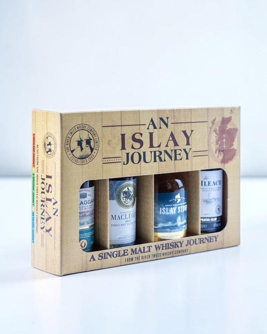 An 'Island Journey' single malt whisky gift set featuring a light wood-grain box design with four miniature bottles visible through a window cutout.