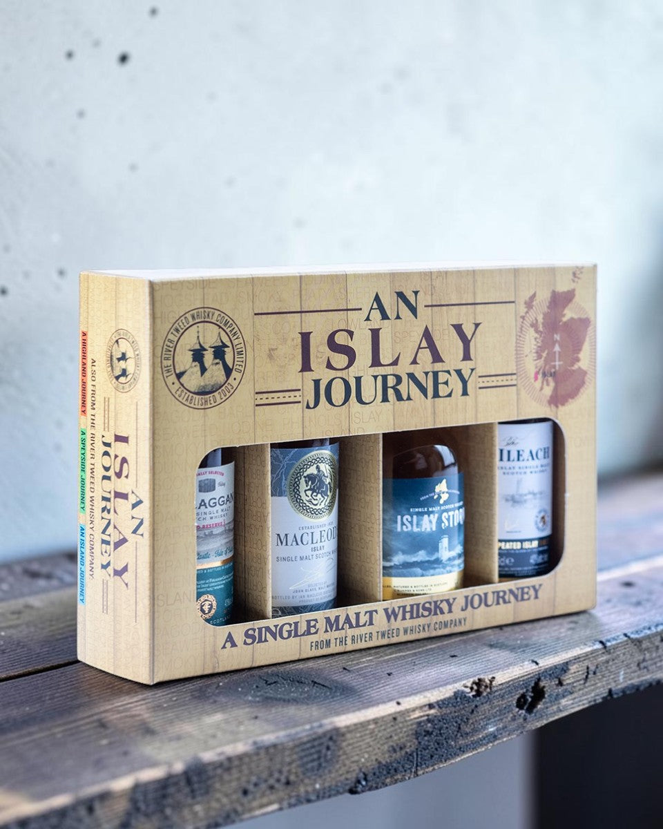 An 'Island Journey' single malt whisky gift set featuring a light wood-grain box design with four miniature bottles visible through a window cutout.
